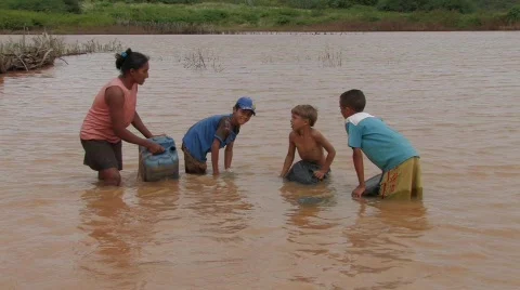 Stock Video of Brazil: Collecting Water from the Lake Stock Footage