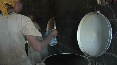 Stock Video of Ethiopia: Woman pours batter to make engera Stock Footage