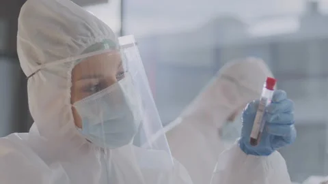 This stock video features a scientist examining a blood sample in a test tube Stock Footage 137541063