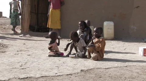 Sudan: Poor children in a IDP camp share a bowl of cereal Stock Footage
