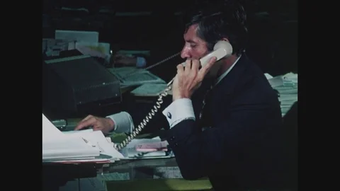 Stockbroker on telephone, using trading machine to trade stocks, 1971 Stock Footage 82514283