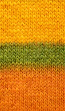 Stocking stitch in yellow, green and orange background Stock Photos