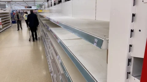 Stockpiling: anonymous shoppers in supermarket with empty shelves Video stock 126877545