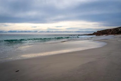 Stokes Bay Beach at sunset with waves and rocks, Australia Stock Photos