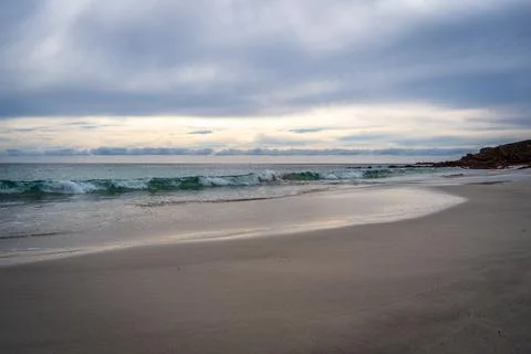 Stokes Bay Beach at sunset with waves and rocks, Australia Stock Photos
