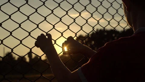 Stolen Child. Child Hands Holding Steel Cage To Child Abduction Stock Footage