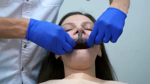 Stomatologist is installing denture mould on lower jaw of woman in dentistry. to Stock Footage 168362933
