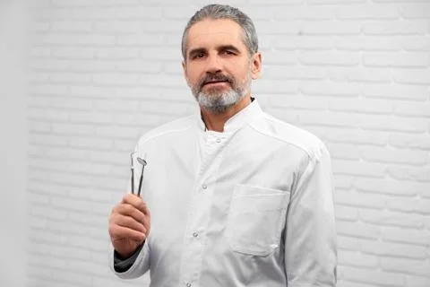 Stomatologist posing with instruments in studio. Stock Photos