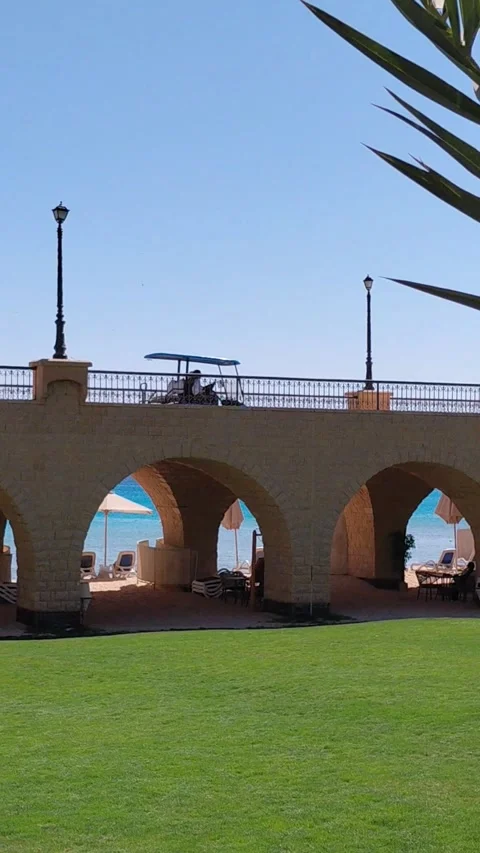 Stone arch bridge and resort beach view through arches in Sahl Hasheesh Stock Footage 337540104