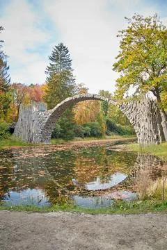 Stone arch bridge Kromlau, called Rakotz Bridge or devils bridge, upright pho Stock Photos