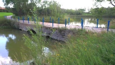 Stone Arch Bridge Over Calm River In Rural Park Stock Footage 333577214