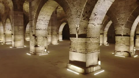 Stone arches and columns line Sultanhani Caravanserai interior - Vaulted Ceiling Stock Footage 340585330