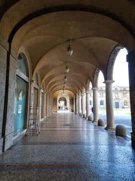 Stone arches at the building on the square. Gothic Italian style Stock Photos