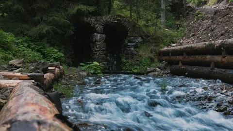Stone arches through which a stream flows. Timelapse Stock Footage 126775627