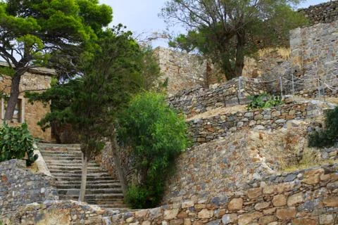 Stone architecture, stone steps, stone walls, trees, Crete, Greece Stock Photos