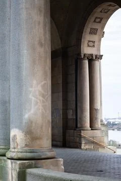 Stone archway with columns under a bridge Stock Photos