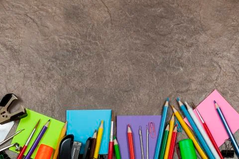 Stone background with bottom border of pencil case supplies 스톡 사진