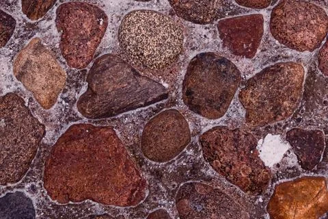 Stone background from dark brown granite cobblestone square Stock Photos