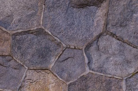 Stone background granite texture. multifaceted dark cobblestone wall elements Stock Photos
