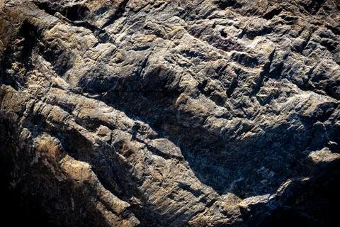 Stone background. Grey solid rocky surface. Natural uneven dark material. Stock Photos