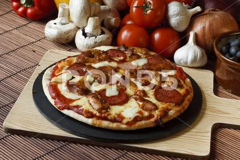 Stone baked meat feast gourmet pizza Stock Photos