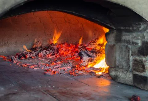 Stone baking oven with live fire Stock Photos