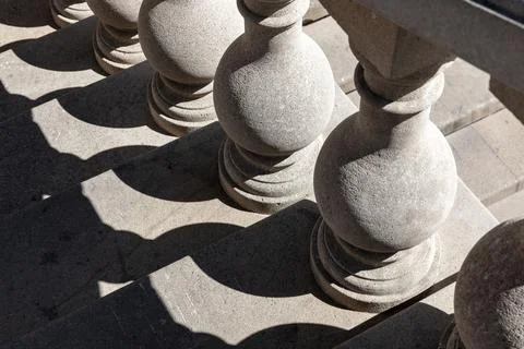 Stone balusters line a staircase, casting intricate geometric shadows Foto stock