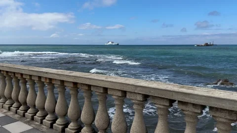 Stone balustrade overlooking the sea with ship under blue sky in Livorno Stock Footage 306959863