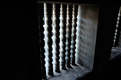 Stone bars on the windows. The window opening of the old house. Stock Photos