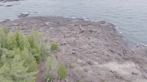 Stone beach on a cold lake, 4k, slow-mo drone shot Stock Footage 243532406