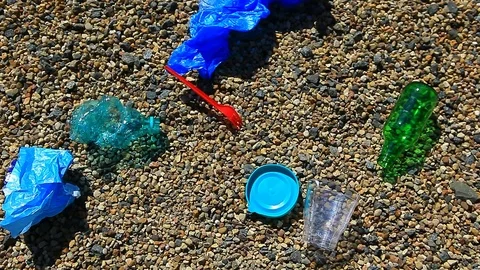 Stone beach plastic bottle package garbage hd footage Stock Footage 107129661