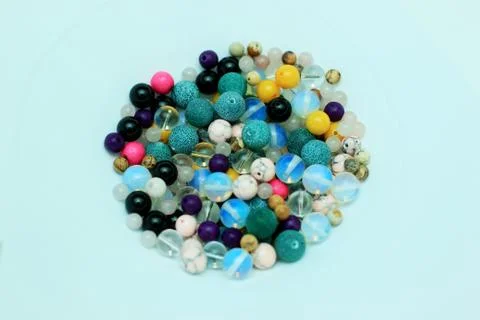 Stone beads of different colors on a white background with a variety of subjects Stock Photos