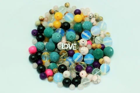 Stone beads of different colors on a white background with a variety of subjects Stock Photos