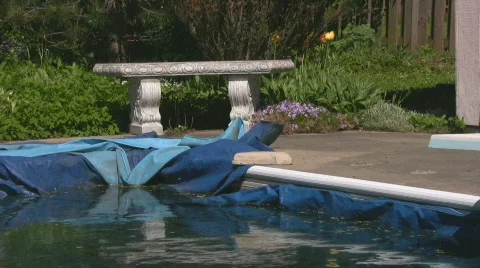 Stone bench and winterized pool in backyard zoom out Stock Footage 544982