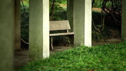 A stone bench composed between white pillars Stock Footage 332681819