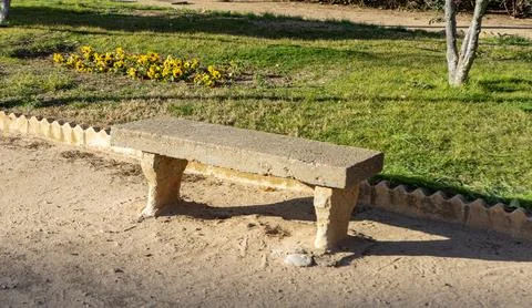 Stone bench located in garden Stock Photos
