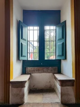 Stone bench over blue window Stock Photos
