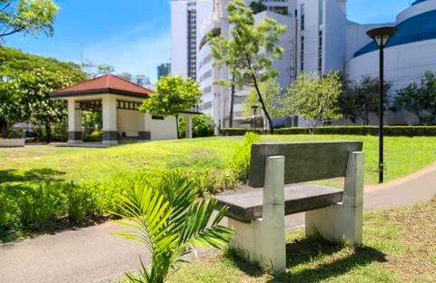 Stone bench in Park in the center of Makati, Philippines Stock Photos