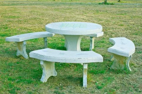 The stone bench in the park Stock Photos