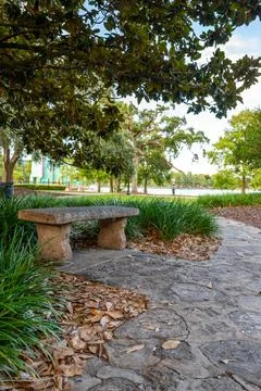 Stone Bench on Shaded Path in Peaceful Park, Orlando, Florida Stock Photos