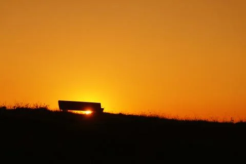 Stone bench at sunset Stock Photos