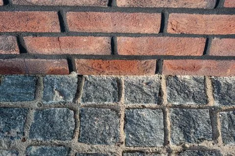 A stone block foundation red brick building structure exterior wall archite.. Stock Photos