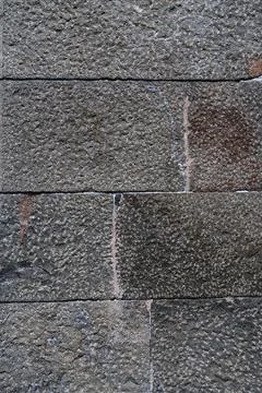 Stone block wall seamless background and texture. Vertical photo. Stock Photos