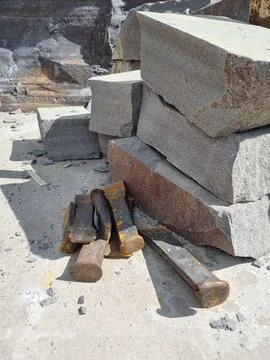 Stone blocks and tools at the construction site Stock Photos