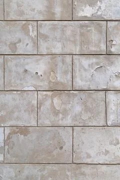 Stone blocks covered with cracked plaster. Backgrounds Stock Photos