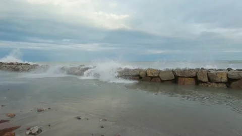 Stone breakwater on sandy seashore during storm Stock-Footage 170068231