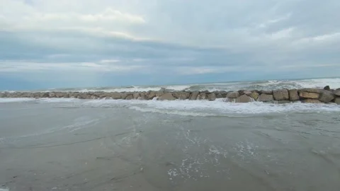 Stone breakwater on sandy seashore during storm Stock-Footage 170068256