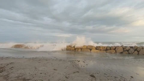 Stone breakwater on sandy seashore during storm Stock-Footage 170068337