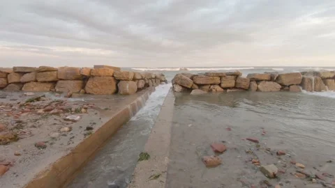 Stone breakwater on sandy seashore during storm Stock-Footage 170068480