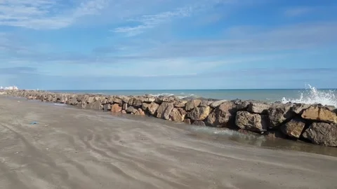 Stone breakwater on sandy seashore  Stock-Footage 168127218